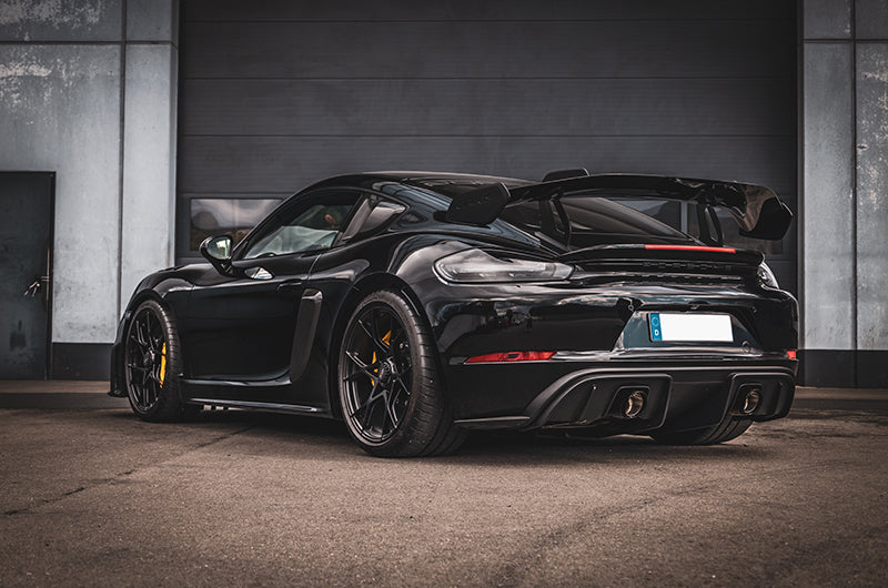 Black Porsche 718 GT4 RS with Capristo exhaust, rear three-quarter