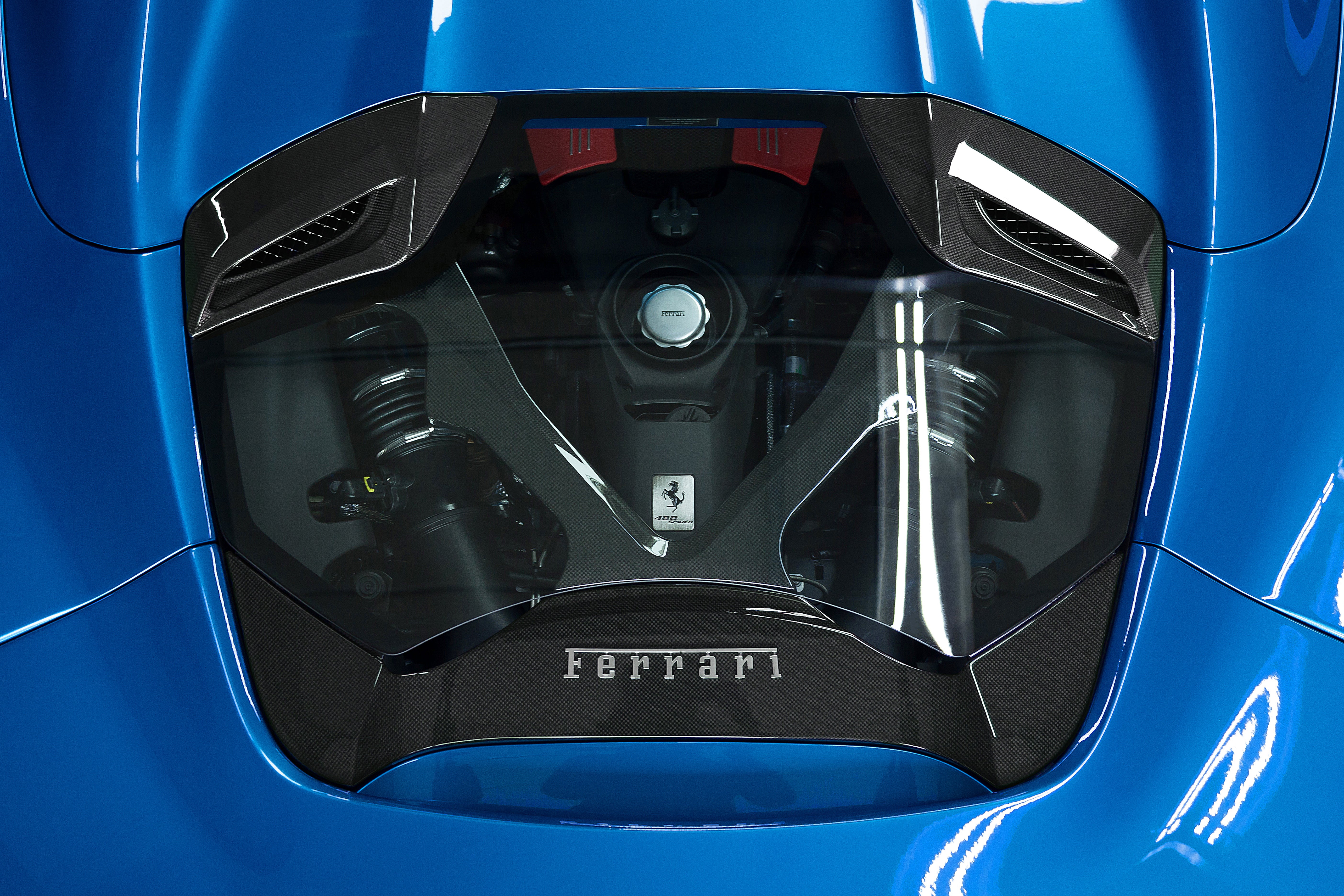 Capristo carbon and glass engine bonnet on a blue Ferrari 488 Spider showing the engine