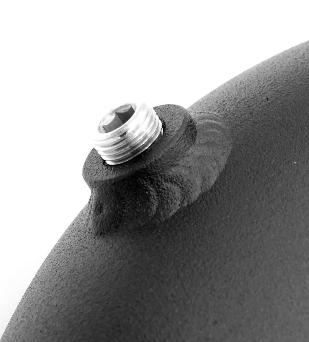 Close-up of plugged injection port on black charge pipe