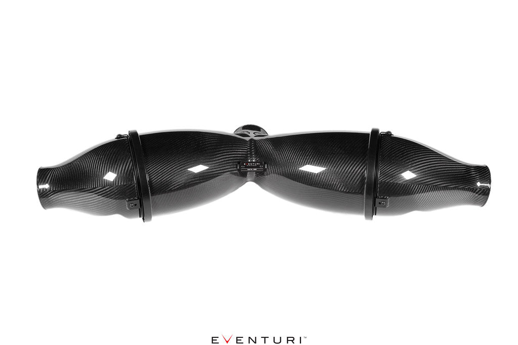 Curved carbon fiber intake tubes with glossy finish and black mounting clamps on white background - Eventuri air intake system for Porsche GT3RS