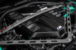Installed Eventuri gloss carbon S58 cover with M badge, seen between the strut brace arms