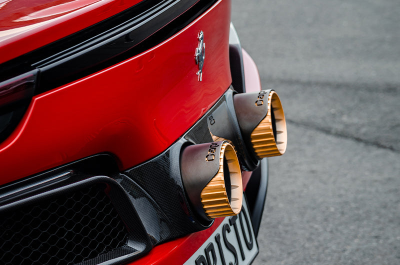 Close-up of Capristo gold tips on Ferrari 296, side angle