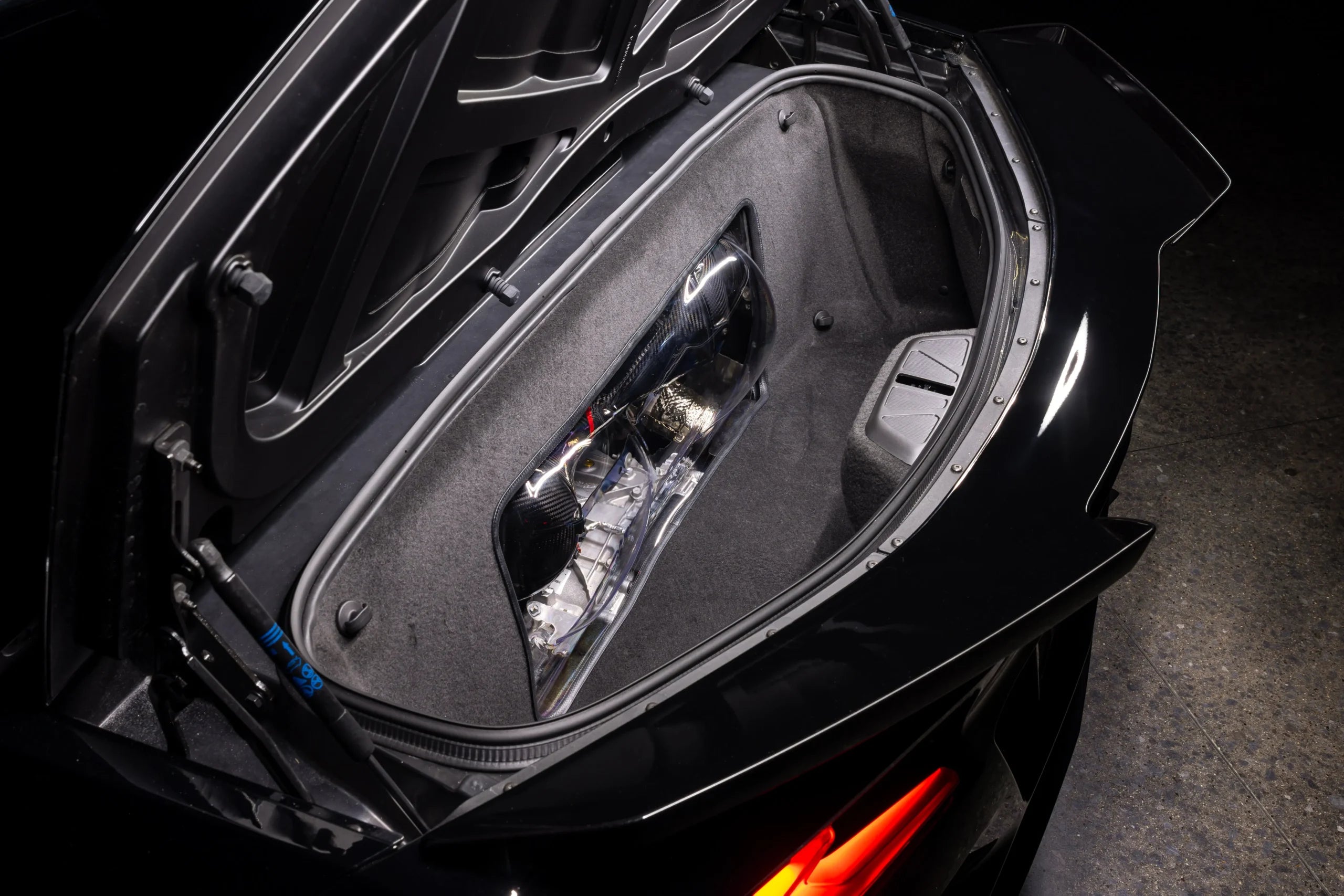 Z06 trunk lid raised, looking down at the carbon intake through the clear trunk panel