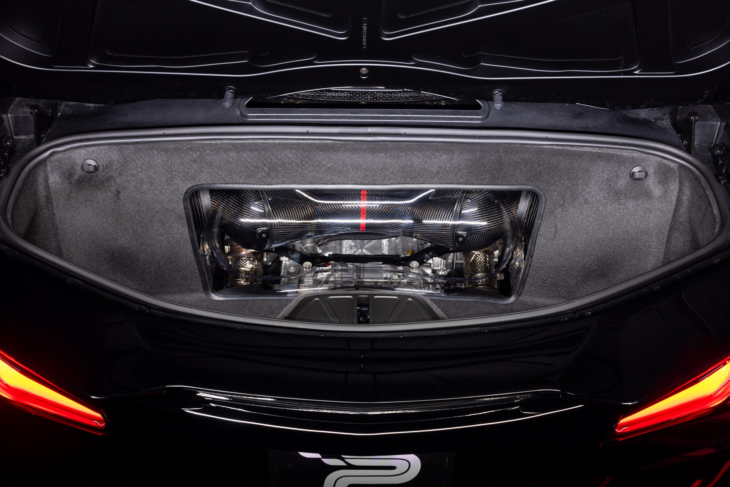 Black Z06 from behind with the trunk open and the Eventuri intake under the clear panel