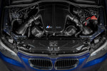 A top view of Eventuri Black Carbon Fiber Intake System V2 for BMW E60 M5 / E63 M6 2006-2010 fitted inside a blue car