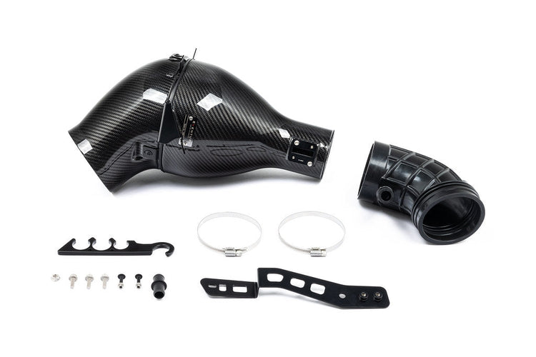 A front view of Eventuri Black Carbon Intake System Lotus Emira V6 2022+ with all its parts with white background