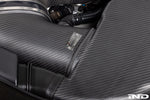 Carbon fiber intake box with label installed in engine bay showing filter housing and connecting hoses - Eventuri cold air intake for BMW M3