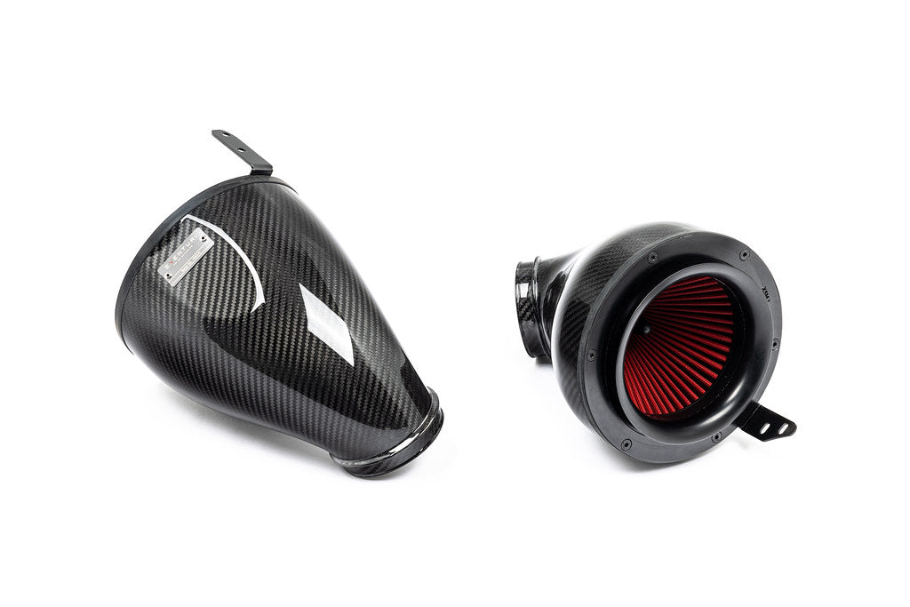 Carbon fiber intake components with glossy finish, including curved airbox and cylindrical filter housing with red filter element - Eventuri intake for BMW X5 M50i