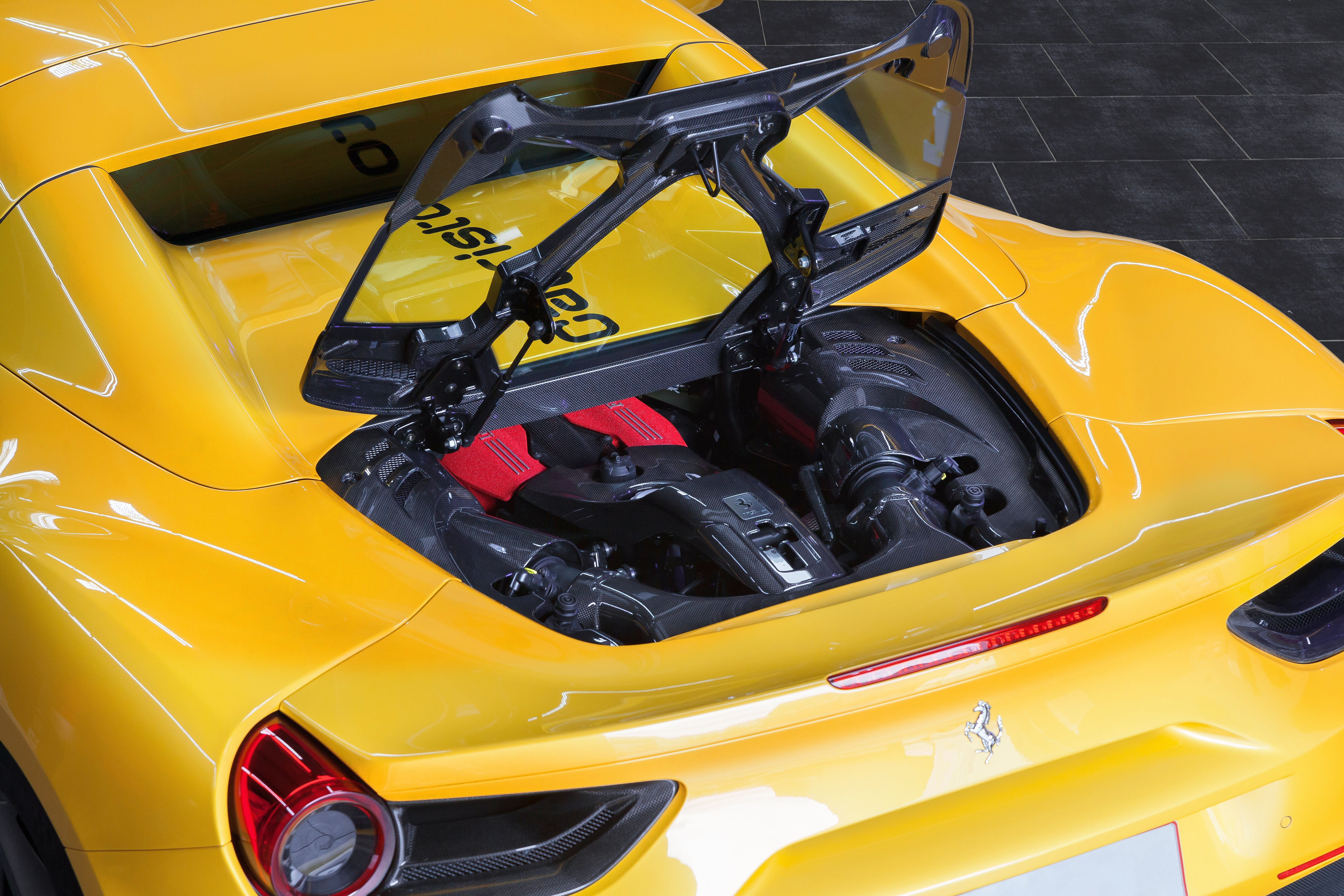 Capristo carbon and glass bonnet raised on a yellow Ferrari 488 Spider