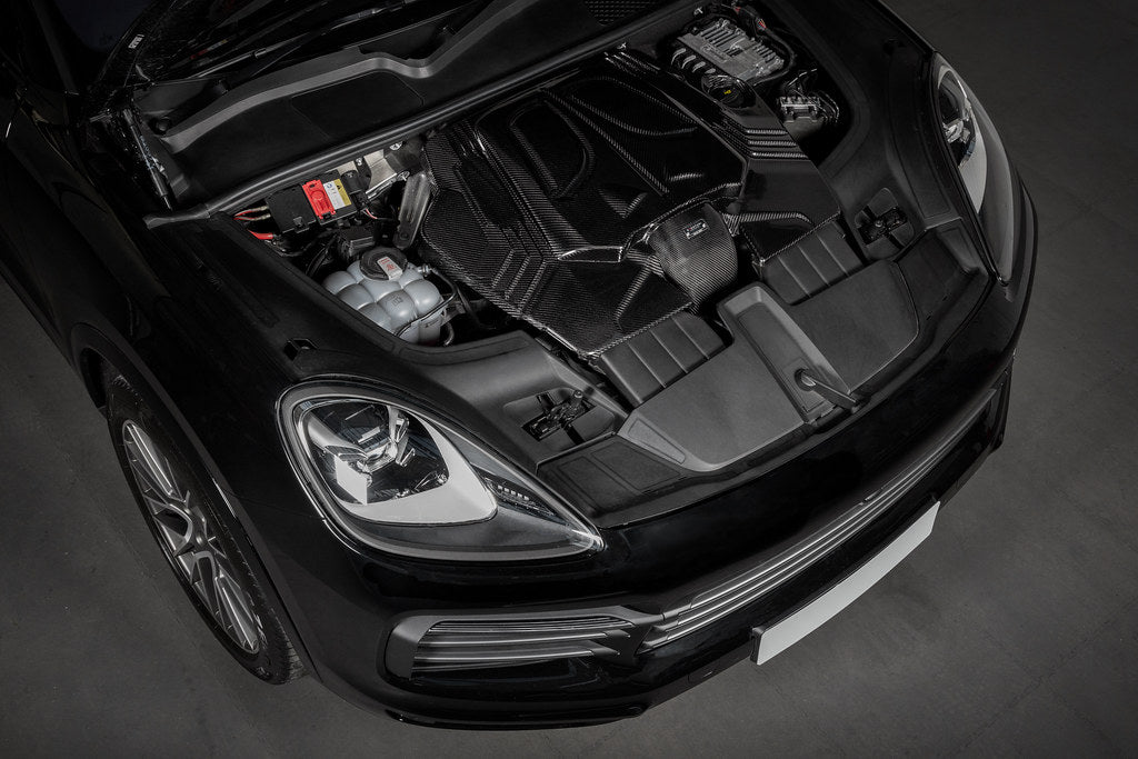 Carbon fiber intake system installed in Porsche engine bay with curved ducting and filter housing visible - Eventuri intake system for Porsche 9YB Cayenne Coupe 9YA Cayenne
