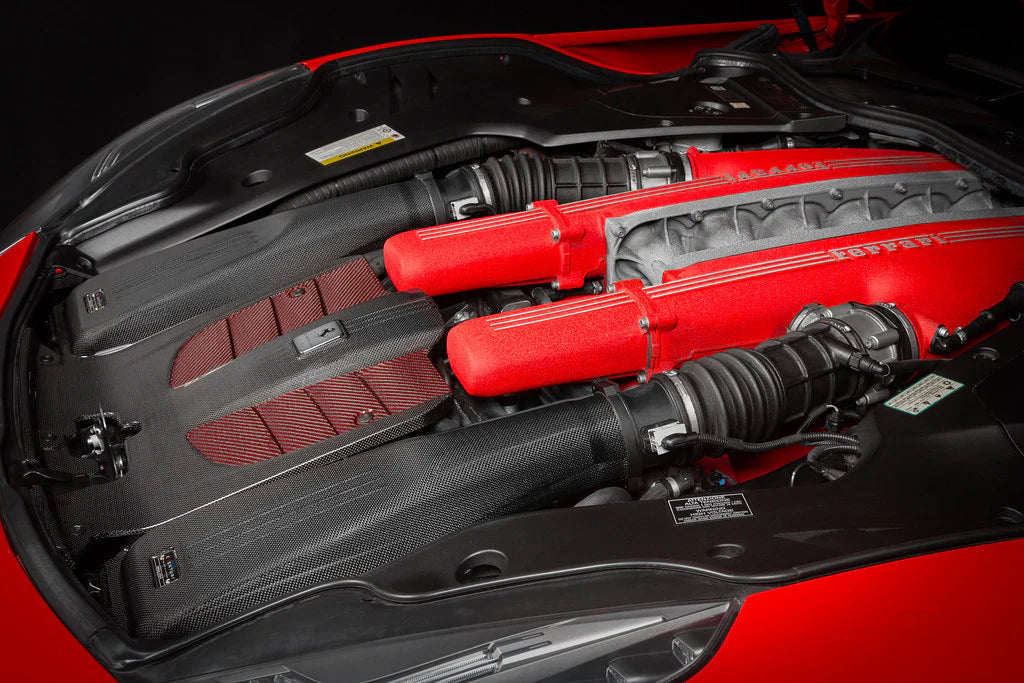 A side close up view of Eventuri Carbon Intake System for Ferrari F12 Berlinetta 2012-2017 fitted inside a red car on a black background