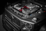 Black carbon fiber intake system with red filter installed in Mercedes G63 engine bay with hood open - Eventuri cold air intake for Mercedes-Benz G63 AMG