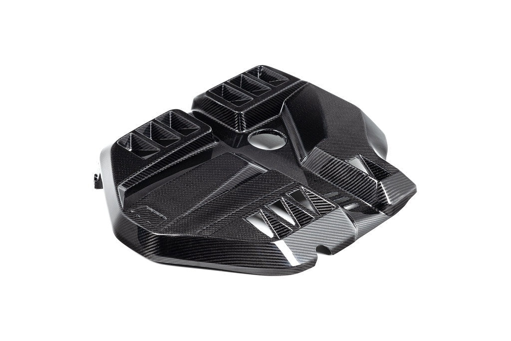 Black carbon fiber engine cover with geometric angular design featuring multiple air intake openings and sculptured surfaces - Eventuri engine cover for BMW M2