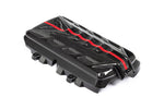 Black carbon fiber engine cover with angular geometric design featuring multiple air vents and red accent stripe across top surface - Eventuri engine cover for Chevrolet Corvette