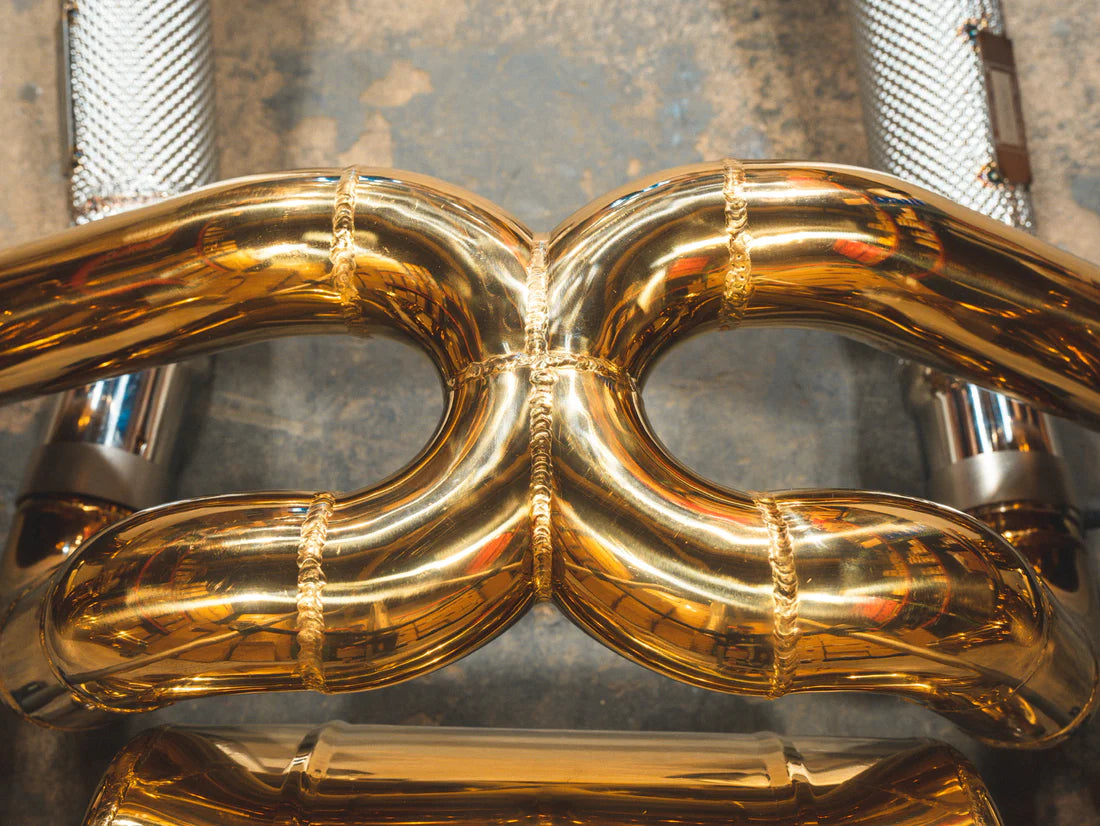 A close up view of Valvetronic Designs Valved Sport exhaust system's pipes on the ground (for Ferrari F430 Scuderia / 16M).