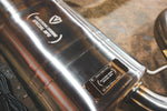 A close-up of the rear muffler casing, featuring an engraved "Valvetronic Designs Special Ops" logo and a riveted identification plate marked for the BMW X3M/X4M.