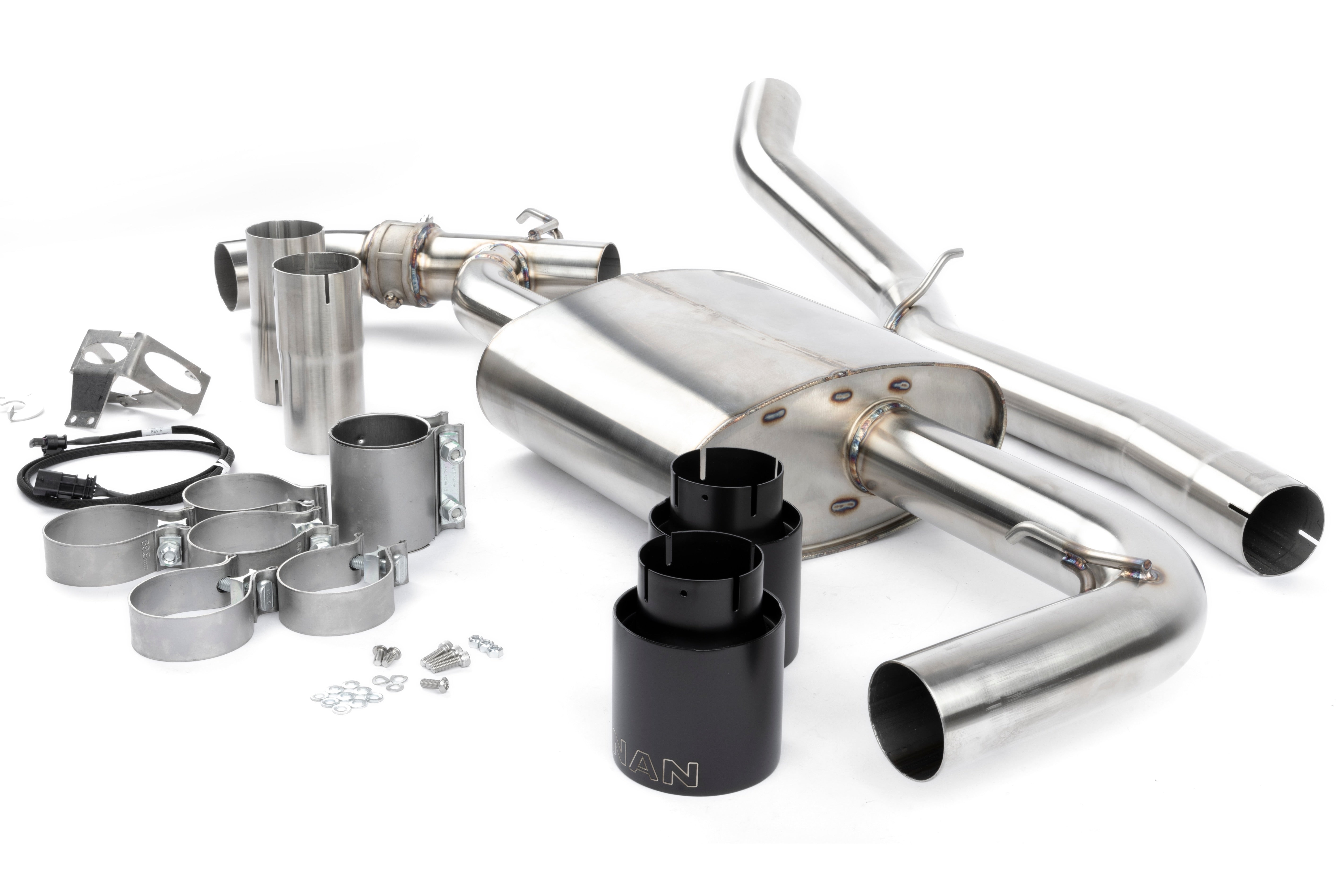 A wide-angle studio shot of the complete Dinan Valved Cat-Back Exhaust System for the BMW X3 M40i. The system is displayed on a white background, showcasing the brushed T304 stainless steel piping, the large central muffler, and the quad 4-inch ceramic coated black tips.