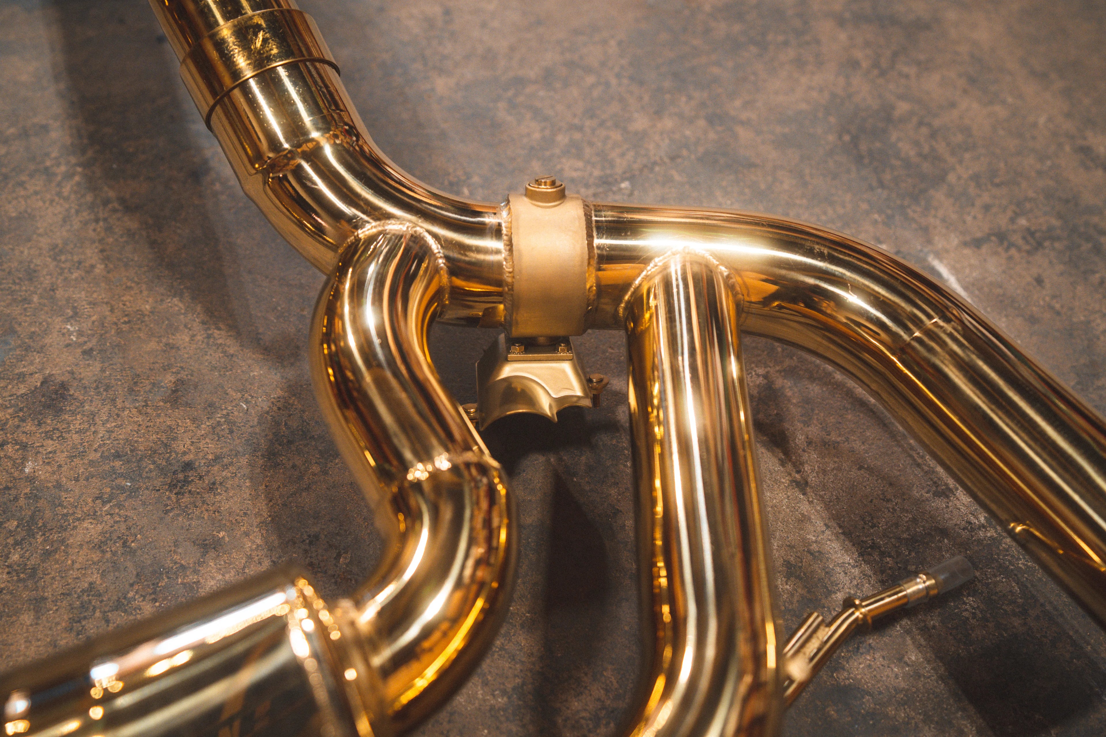 Close-up of the exhaust valve mechanism and high-quality welds on the gold-plated piping.