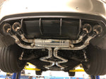 A close up view of Valvetronic Designs Valved Sport Exhaust System fitted on a lifted car (for BMW X5M F85 / X6M F86).