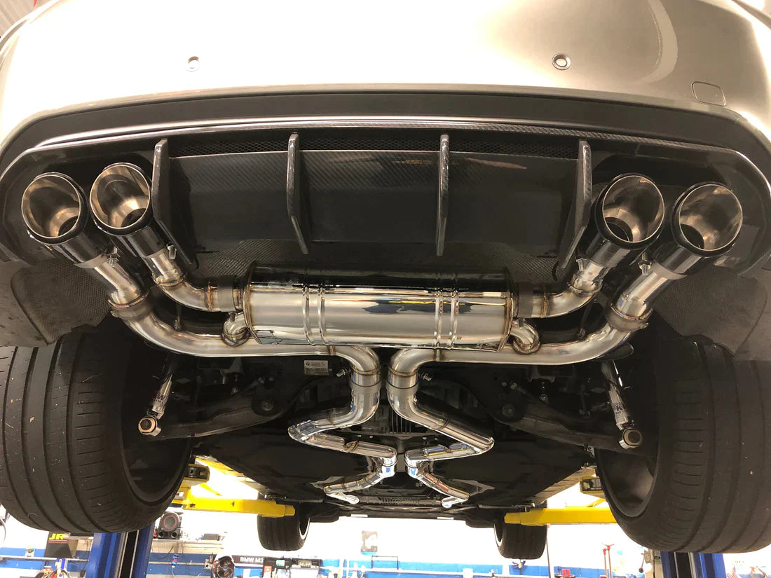 A close up view of Valvetronic Designs Valved Sport Exhaust System fitted on a lifted car (for BMW X5M F85 / X6M F86).