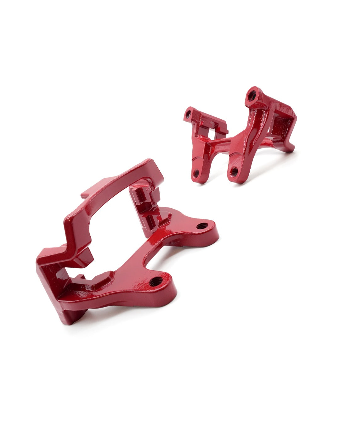 Two red rear-caliper carrier brackets