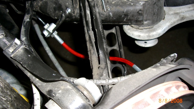 A close up view of rear brakes lines installed of the Evolution Racerwerks Stainless Steel Brake Lines for BMW 135i/335i/128i/1M