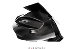 Black carbon fiber intake housing with curved air scoop opening and metal nameplate on white background - Eventuri intake for Toyota Supra