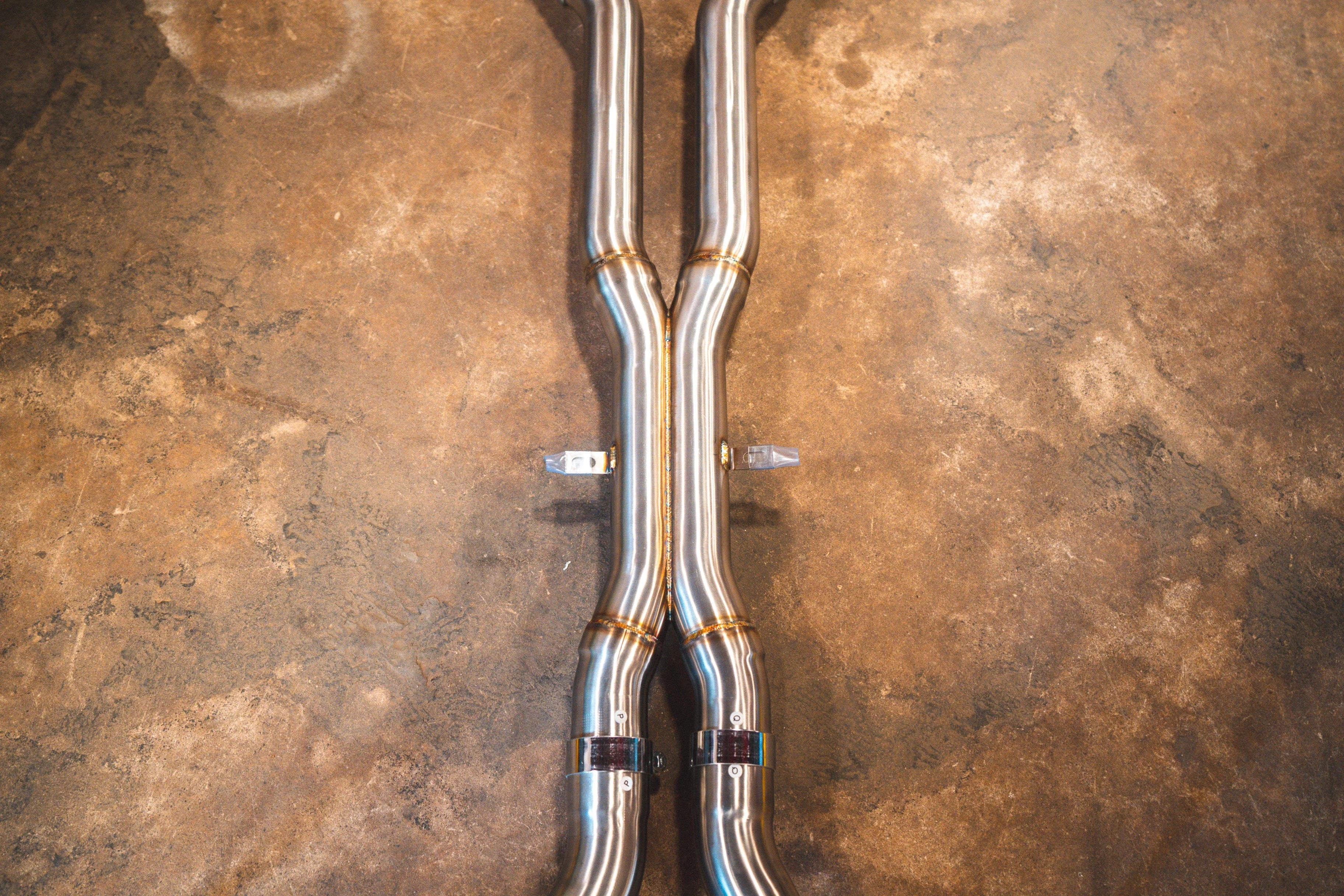 Top-down view of the X-pipe section, showing the center merge point and mounting hardware.