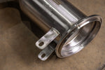 Close-up of V-band flange and TIG-welded mounting brackets on Valvetronic Designs Porsche 992 GT3 high-flow downpipes.