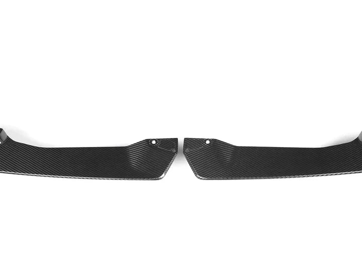 A front view of AUTOTECKNIC DRY CARBON PERFORMANTE FRONT SPLITTER SET - BMW G20 3-SERIES M-SPORT LCI 2022+ with white background