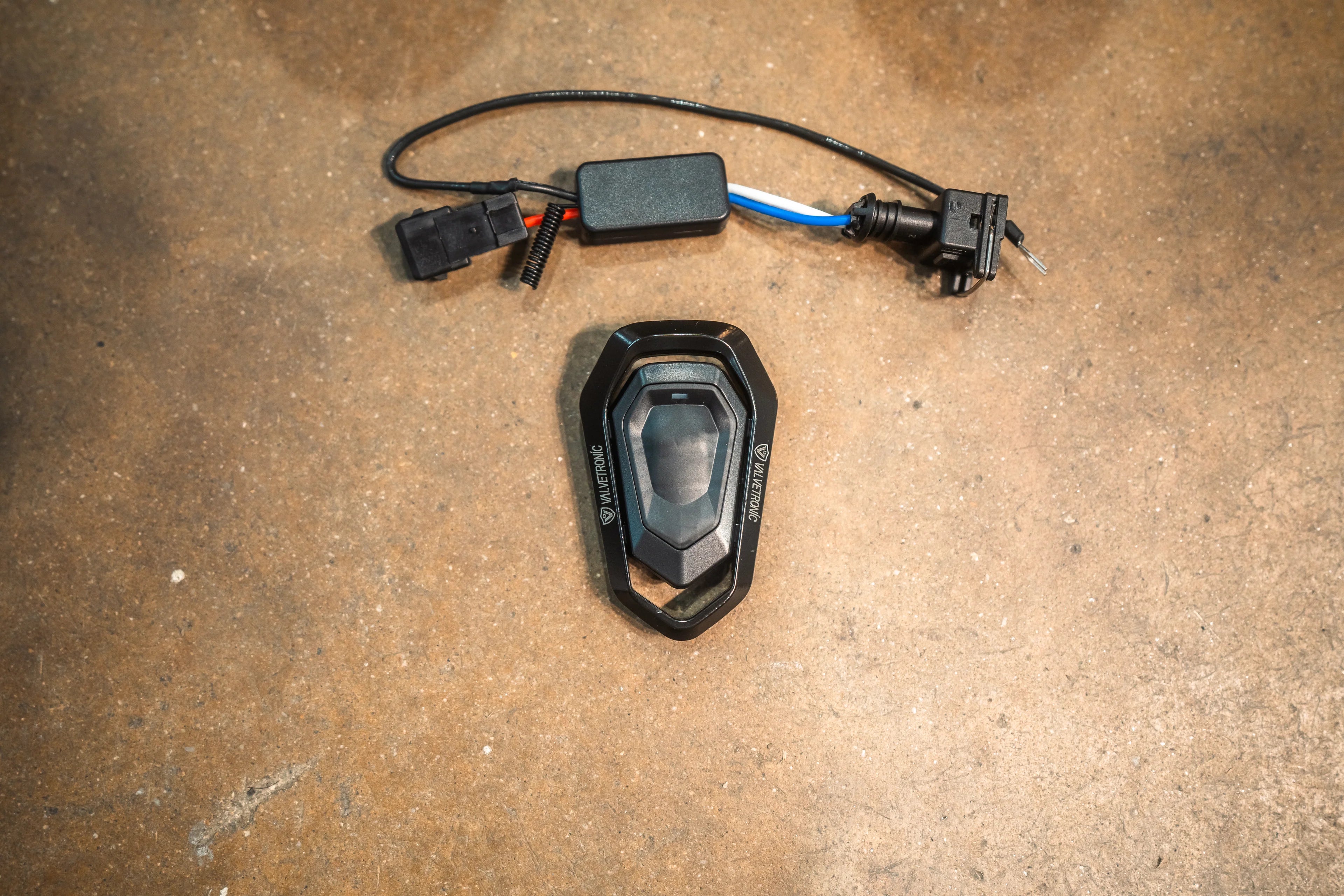 A wireless remote control key fob and wiring harness used for controlling the exhaust valve system.