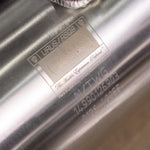 Close-up of the laser-etched identification plate on a Valvetronic Designs downpipe, confirming compatibility for Lamborghini Urus.