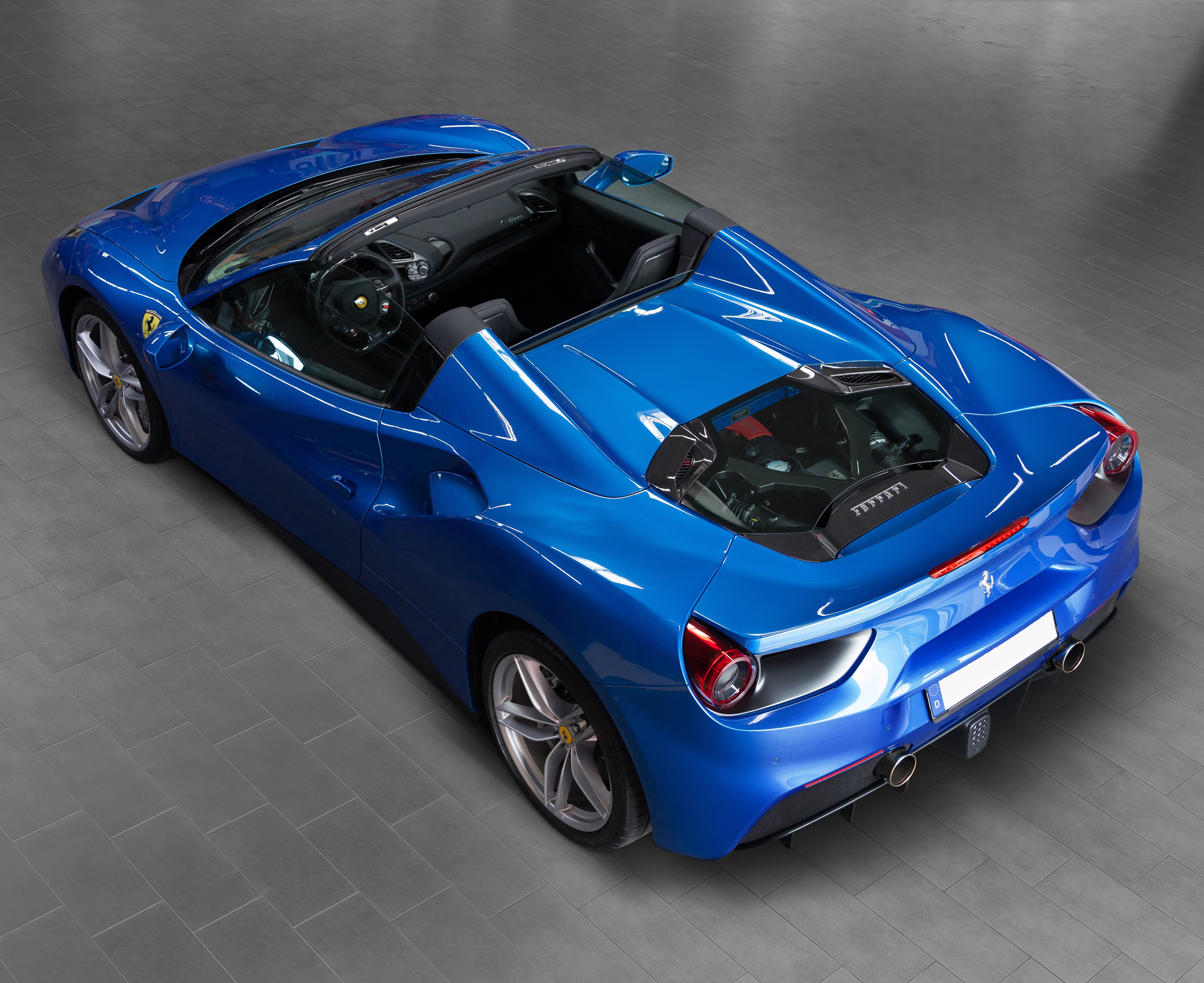 Capristo carbon and glass engine bonnet on a blue Ferrari 488 Spider, overhead view