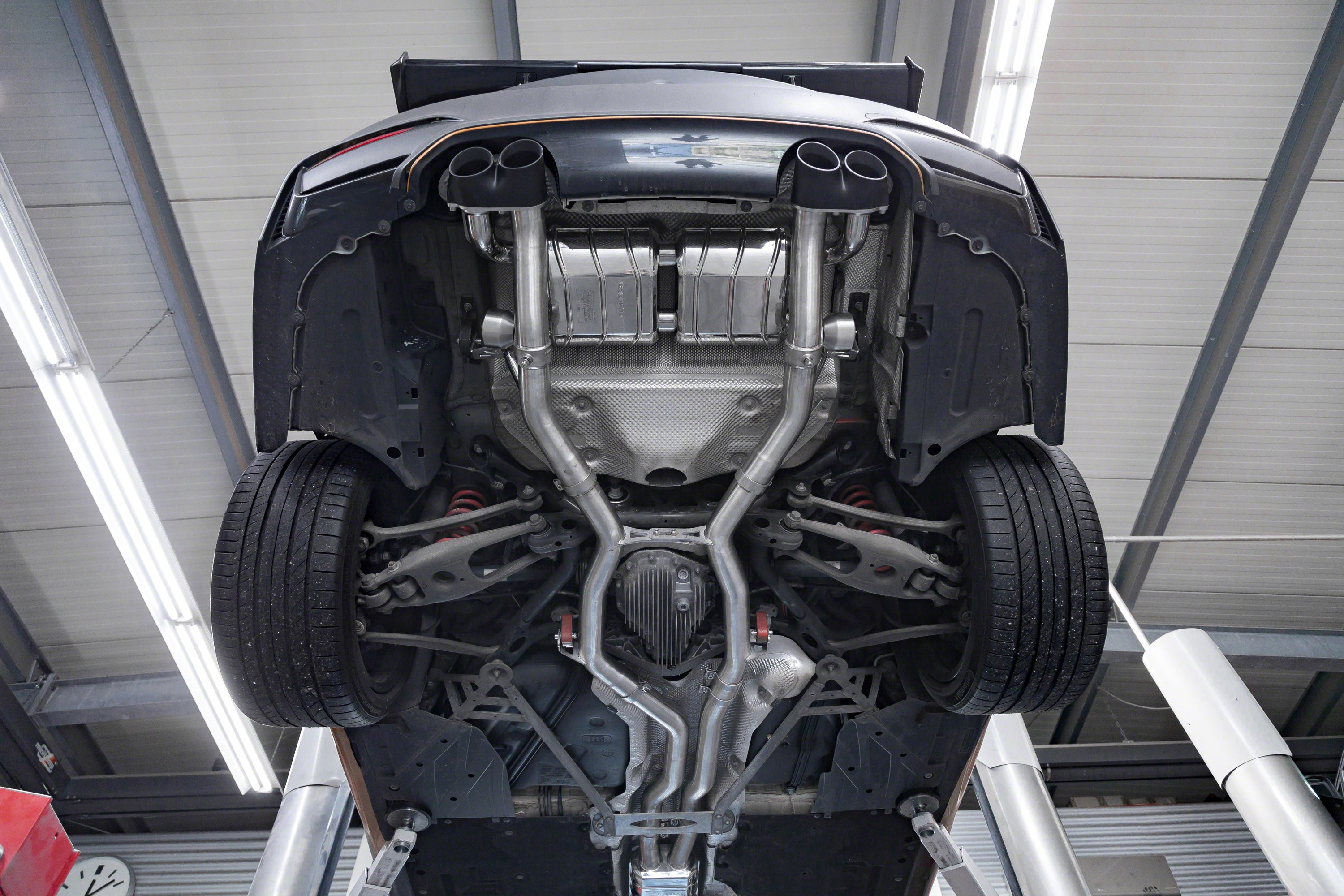 BMW M4 underside with the Capristo valved exhaust and black ceramic tips installed
