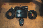 Overhead view of the valve controller kit including the electronic control box, wiring harnesses, and remote key fob.