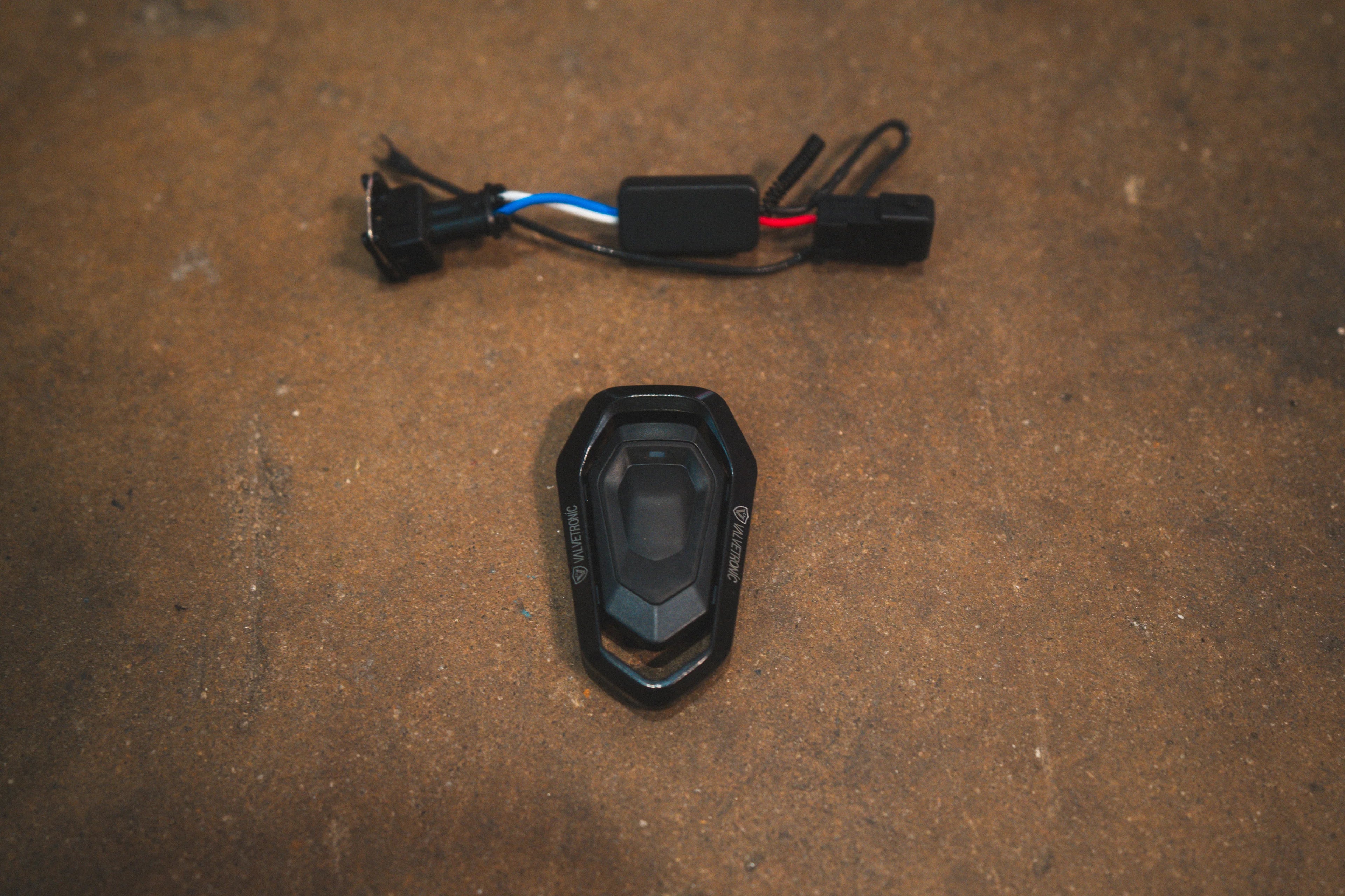 A top-down view of the electronic valve controller module and its accompanying wiring harness.