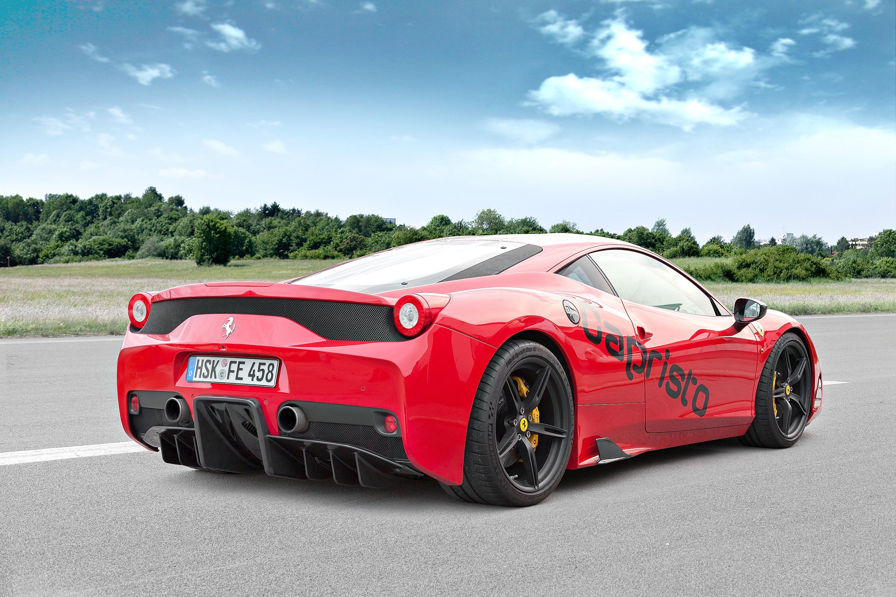 Capristo carbon fiber rear diffuser on a red Ferrari 458 Speciale, rear quarter