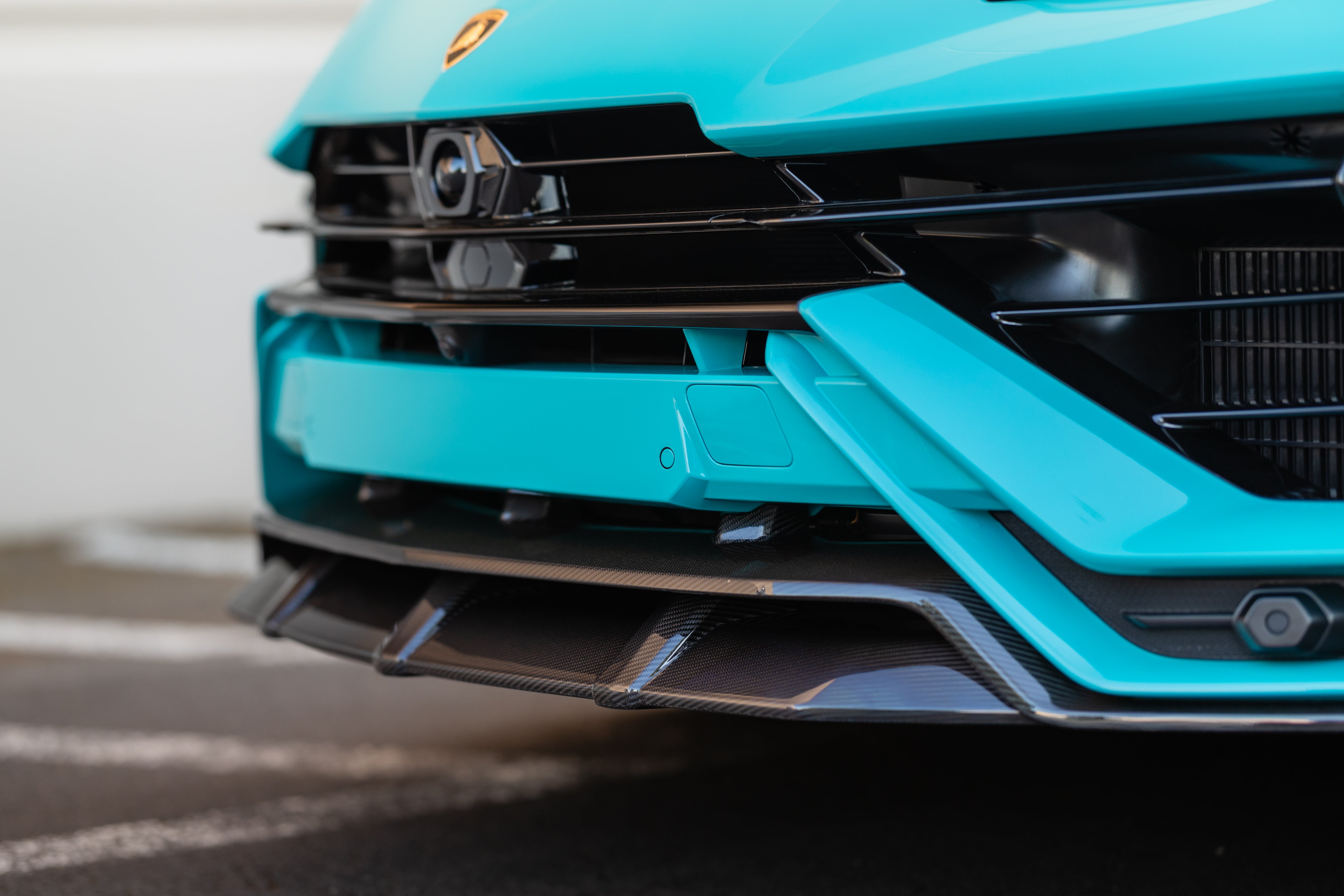 Close-up of the 2-piece carbon front splitter on the Urban Urus S