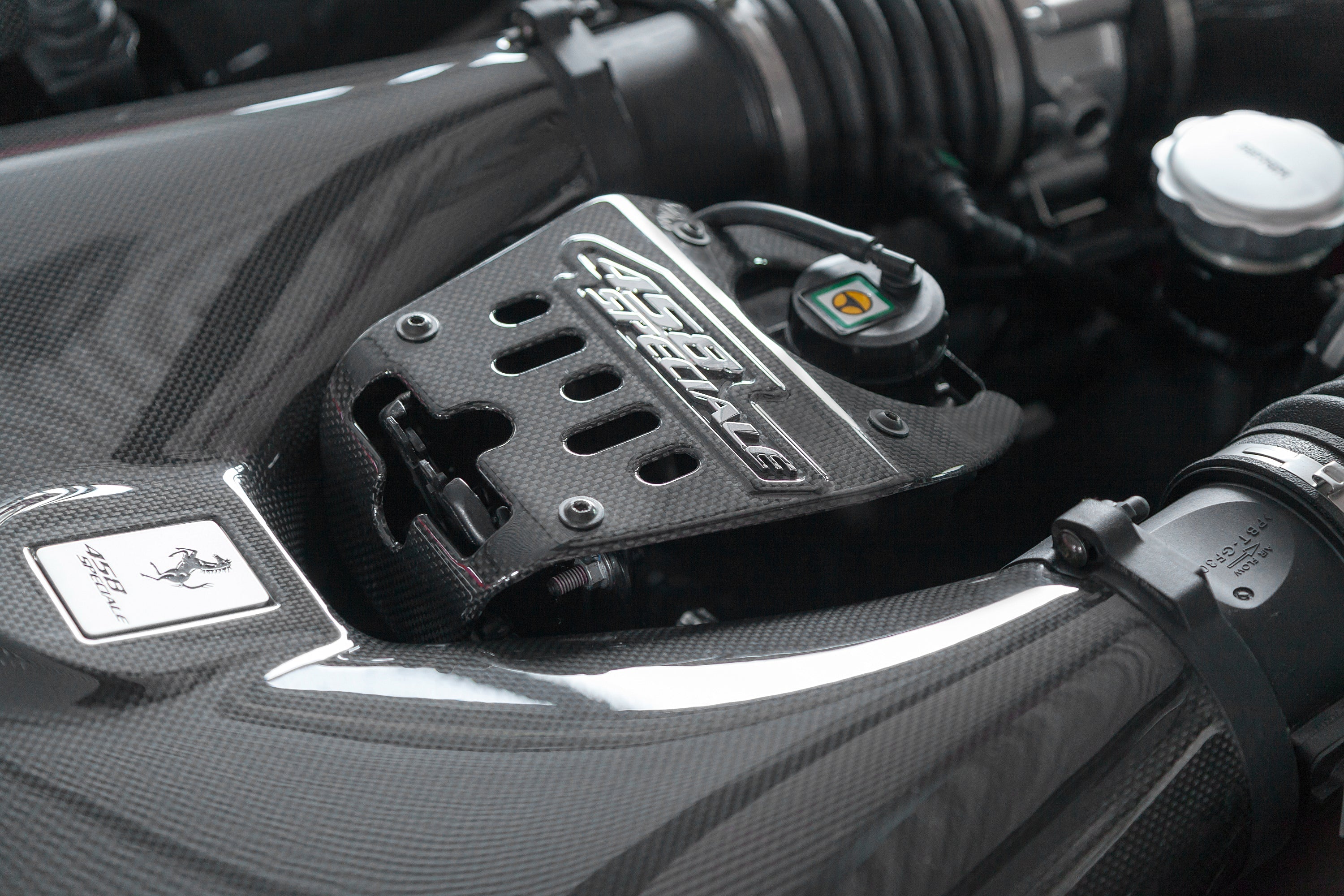 Close-up of Capristo carbon lock cover in a Ferrari 458 Speciale engine bay