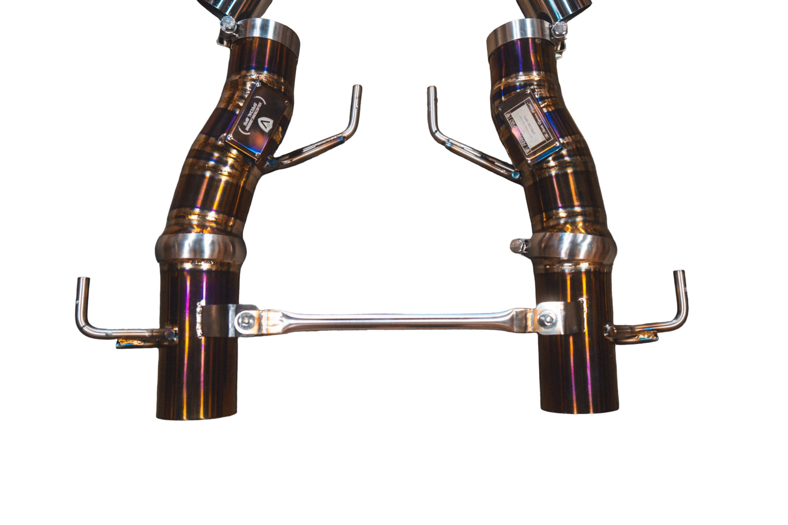 Ferrari SF90 Stradale Valvetronic exhaust: pair of heat-tinted titanium F1 pipes on white linked by a rod