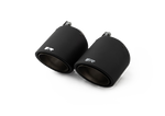 Pair of black carbon angled tail pipes, dark backdrop, Carbon Angled 102mm tips for the Remus G87 M2 Sport Axle-Back Exhaust
