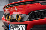 Gold-finish Capristo twin tailpipes in carbon frame on a red Ferrari 296
