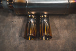 Direct top-down view of the dual exhaust tips integrated into the titanium muffler, showing the etched Valvetronic branding.