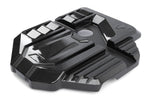 A high-gloss Dinan carbon fiber engine cover for BMW G8x M2, M3, and M4 (S58 engine), featuring a 2x2 twill weave with contrasting matte carbon fiber accents, vertical cylinder callouts, and white Dinan logo branding.