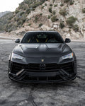 Black Lamborghini Urus head-on on a mountain road