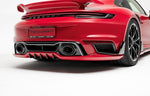 A wide back view of TECHART Rear Bumper Porsche 992 Turbo /S fitted on a red car with a white background