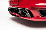 A close up back view of TECHART Rear Bumper Porsche 992 Turbo /S fitted on a red car with a white background