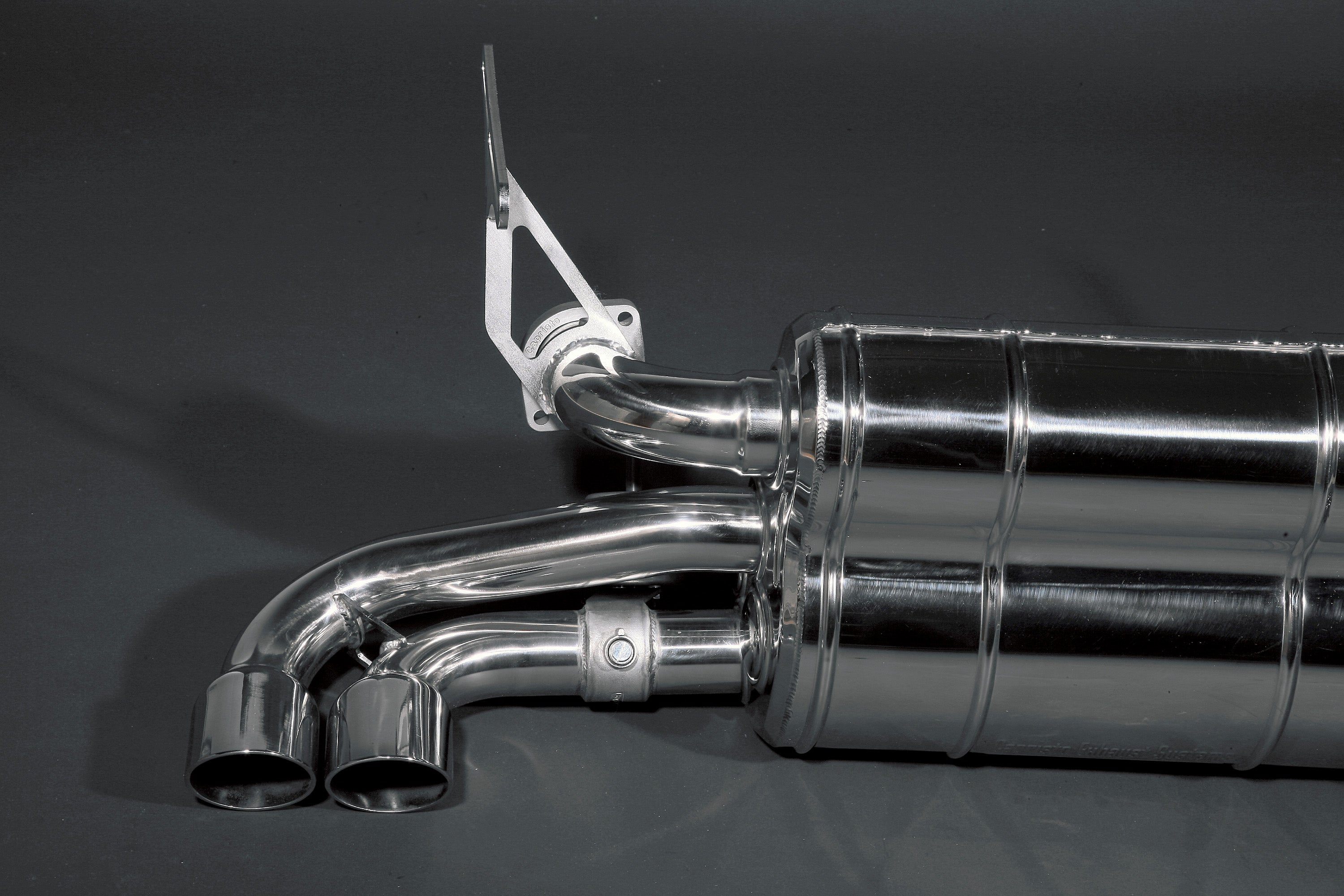 Side view of Capristo Ferrari 348 valved exhaust with black-tipped round outlets and bracket