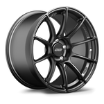 Dark gunmetal forged wheel with seven-spoke design and center cap on white background - APEX Wheels wheel for 18x12 ET42 5x120.65 - Satin Black
