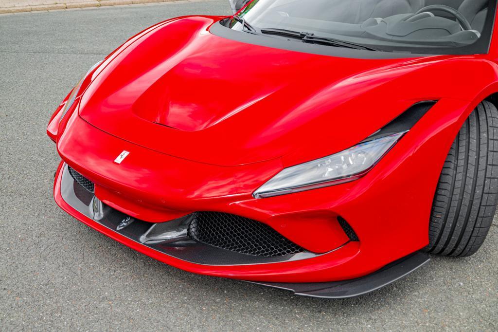 Red Ferrari F8 with Capristo carbon front spoiler, front three-quarter
